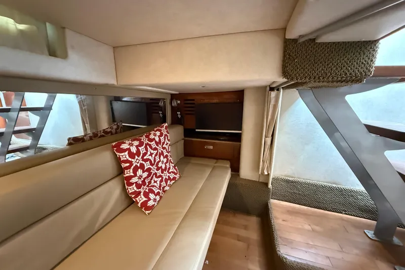  Yacht Photos Pics Interior of 2012 Sea Ray 370 Sundancer with beige seating and red floral pillow.