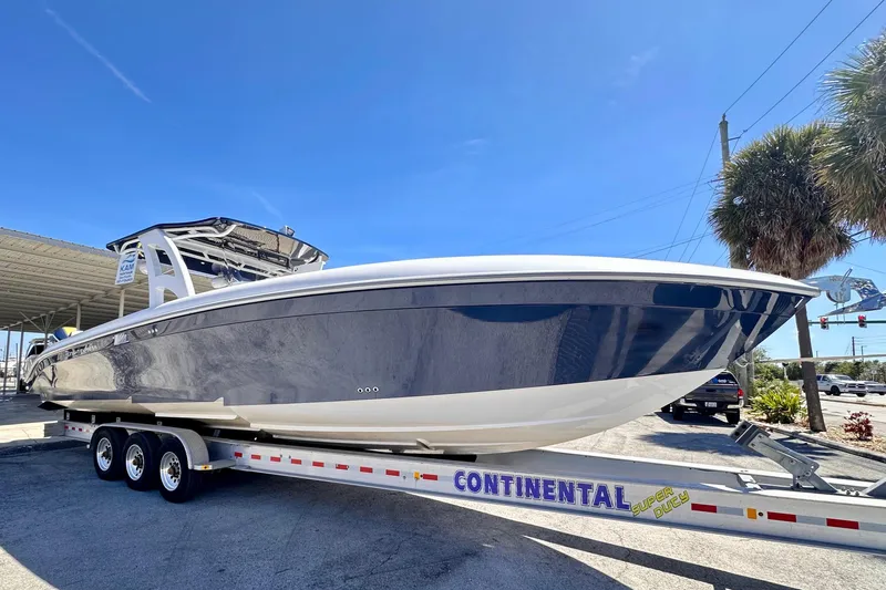  Yacht Photos Pics 2022 Midnight Express 37 Open boat on trailer under clear blue sky.