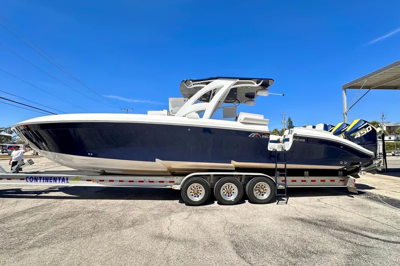  Yacht Photos Pics 2022 Midnight Express 37 Open boat on trailer under clear blue sky.
