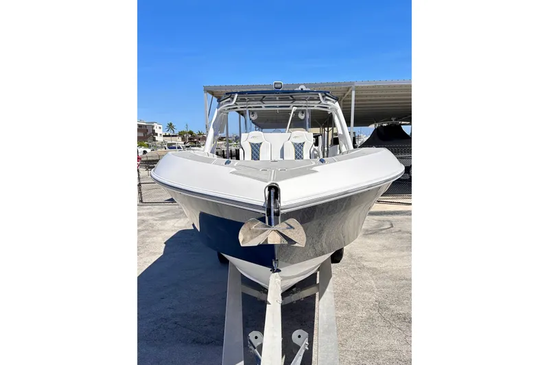  Yacht Photos Pics 2022 Midnight Express 37 Open boat on trailer under clear blue sky.