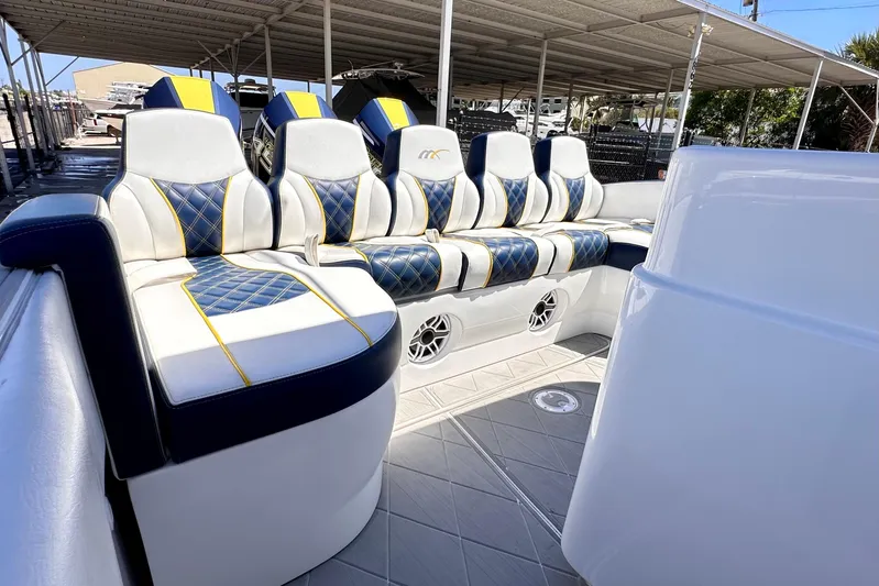  Yacht Photos Pics Luxurious seating on 2022 Midnight Express 37 Open boat, featuring blue and yellow accents.