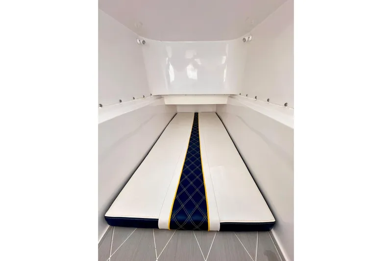  Yacht Photos Pics 2022 Midnight Express 37 Open cabin interior with sleek white and blue cushioned seating.