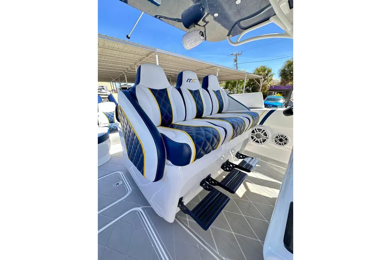  Yacht Photos Pics Luxurious seating on 2022 Midnight Express 37 Open boat, featuring blue and white upholstery.