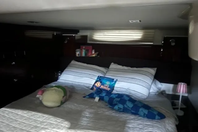  Yacht Photos Pics Cozy bedroom in 2014 Meridian 441 Sedan yacht with plush toys and striped bedding.