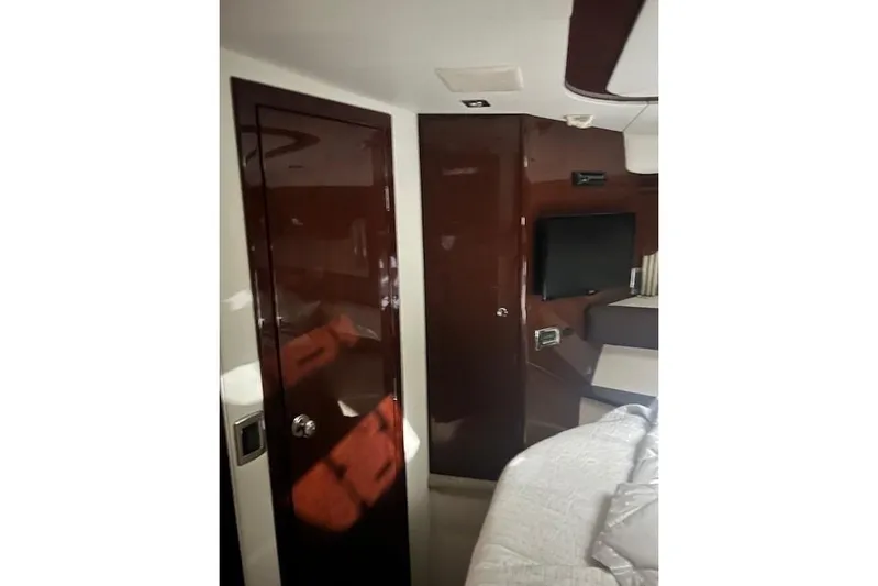  Yacht Photos Pics Interior of 2014 Meridian 441 Sedan yacht with sleek wood finish and mounted TV.