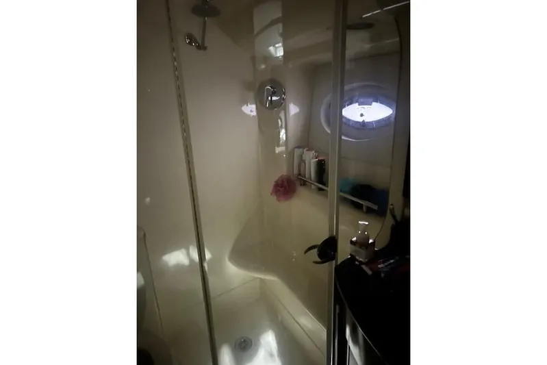 Yacht Photos Pics Shower area in 2014 Meridian 441 Sedan yacht with glass door and porthole window.