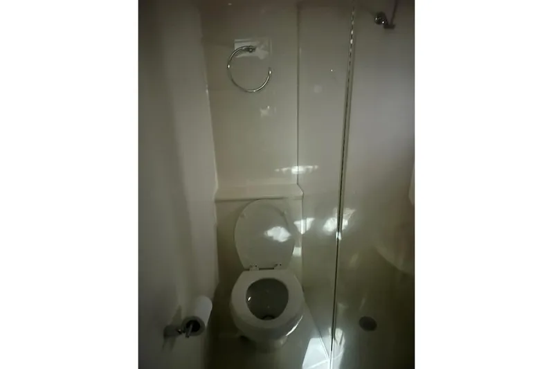  Yacht Photos Pics Bathroom interior of 2014 Meridian 441 Sedan yacht, featuring a toilet and shower area.