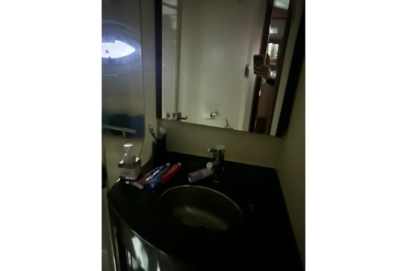  Yacht Photos Pics Bathroom vanity in 2014 Meridian 441 Sedan yacht with toiletries and mirror.