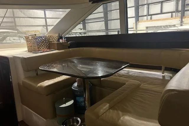  Yacht Photos Pics Interior of 2014 Meridian 441 Sedan yacht with beige seating and dining table.
