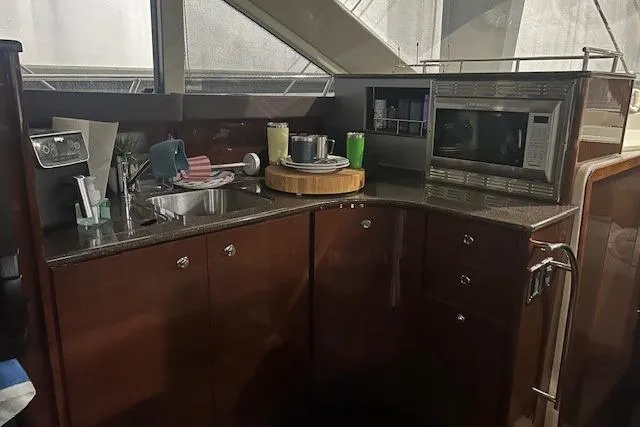  Yacht Photos Pics 2014 Meridian 441 Sedan yacht kitchen with sink, microwave, and countertop accessories.