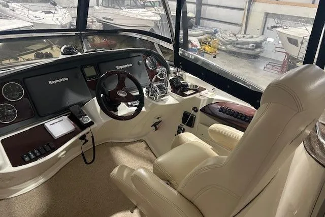  Yacht Photos Pics Interior of 2014 Meridian 441 Sedan yacht cockpit with steering wheel and navigation equipment.