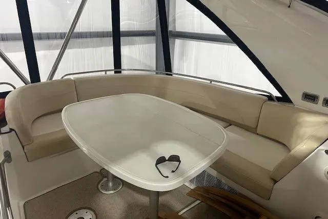  Yacht Photos Pics 2014 Meridian 441 Sedan yacht interior with beige seating and table, featuring sunglasses.