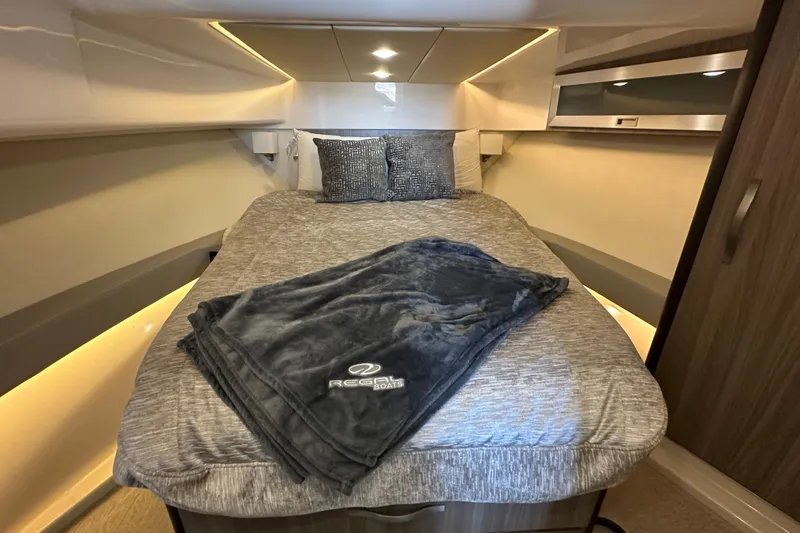  Yacht Photos Pics Luxurious cabin interior of 2021 Regal 36 XO yacht with cozy bedding.