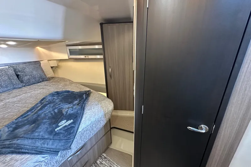  Yacht Photos Pics 2021 Regal 36 XO yacht interior cabin with bed, closet, and modern design.