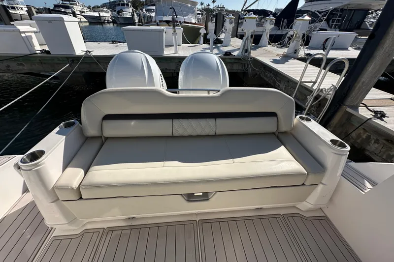  Yacht Photos Pics 2021 Regal 36 XO boat with cushioned seating and twin engines at a marina.
