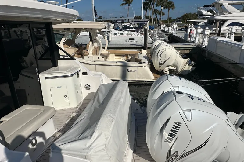  Yacht Photos Pics 2021 Regal 36 XO boat with Yamaha engines docked at a marina.