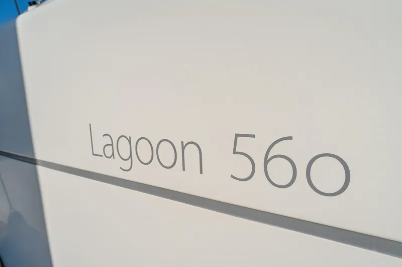 Worth The Wait Yacht Photos Pics Close-up of 2012 Lagoon 560 yacht model name on white surface.