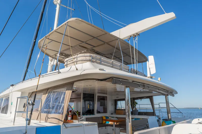 Worth The Wait Yacht Photos Pics Luxurious 2012 Lagoon 560 catamaran with spacious deck and canopy, sailing on calm waters.