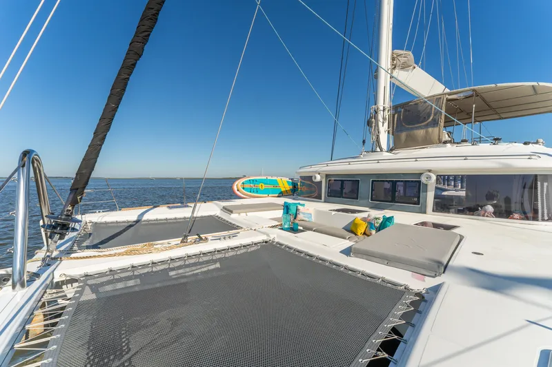 Worth The Wait Yacht Photos Pics Luxurious 2012 Lagoon 560 catamaran with spacious deck and seating, sailing on open water.