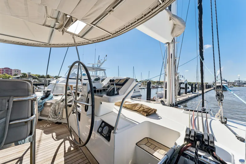 Worth The Wait Yacht Photos Pics Luxurious 2012 Lagoon 560 catamaran docked at marina, featuring spacious helm and modern design.