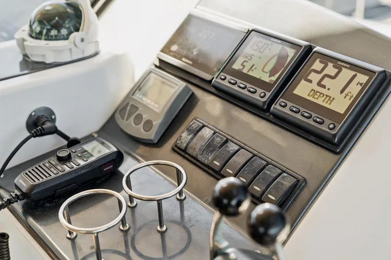 Worth The Wait Yacht Photos Pics Control panel of 2012 Lagoon 560 yacht with navigation instruments and depth display.