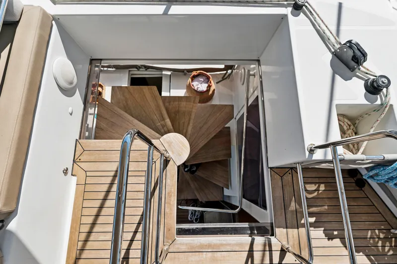 Worth The Wait Yacht Photos Pics Staircase on 2012 Lagoon 560 yacht, featuring wooden steps and sleek design elements.