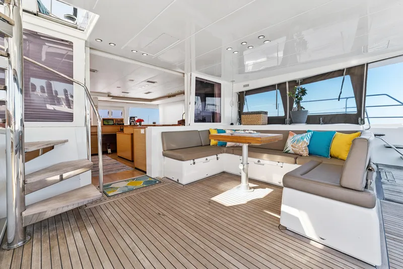Worth The Wait Yacht Photos Pics Luxurious 2012 Lagoon 560 yacht interior with modern seating and vibrant cushions.