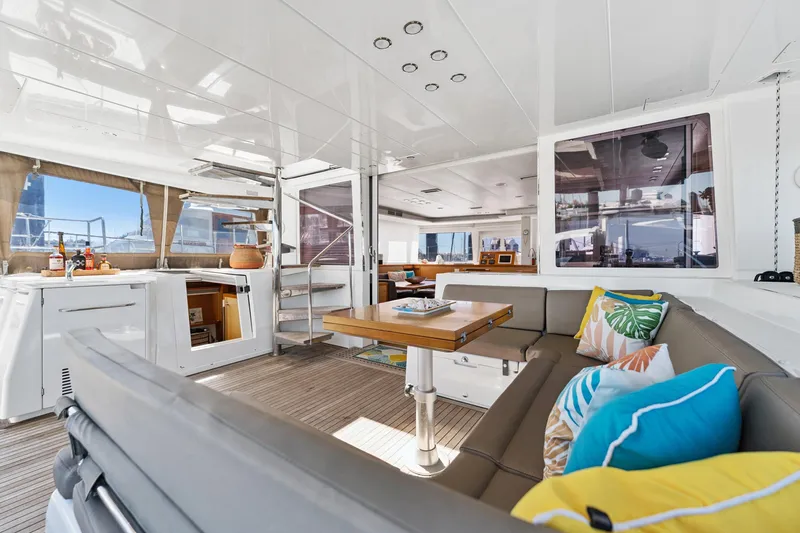 Worth The Wait Yacht Photos Pics Luxurious interior of 2012 Lagoon 560 yacht with modern seating and vibrant cushions.