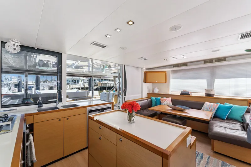 Worth The Wait Yacht Photos Pics Luxurious interior of 2012 Lagoon 560 yacht with modern kitchen and cozy seating area.