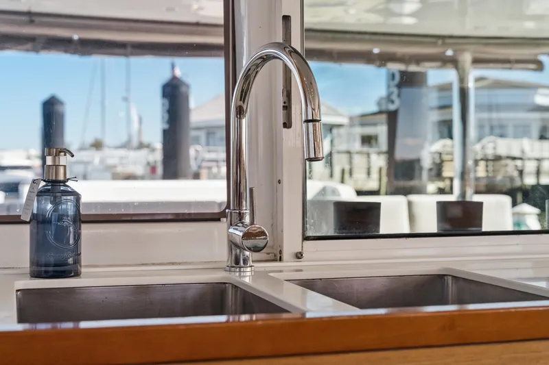 Worth The Wait Yacht Photos Pics Modern kitchen sink and faucet on 2012 Lagoon 560 yacht, with marina view.