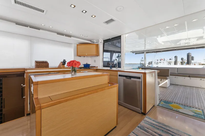 Worth The Wait Yacht Photos Pics Luxurious interior of 2012 Lagoon 560 yacht with modern kitchen and spacious deck area.