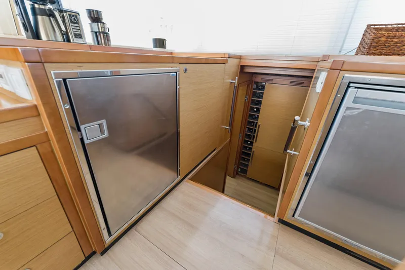 Worth The Wait Yacht Photos Pics Luxurious 2012 Lagoon 560 yacht interior with modern kitchen and wine storage.