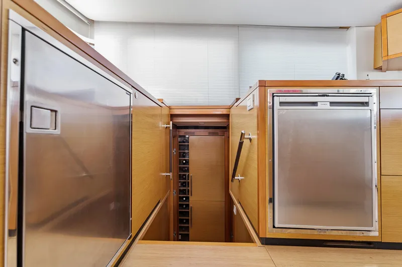 Worth The Wait Yacht Photos Pics Interior of 2012 Lagoon 560 yacht featuring modern kitchen appliances and wooden cabinetry.