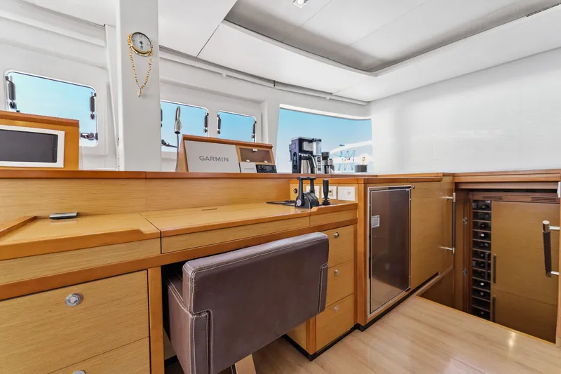 Worth The Wait Yacht Photos Pics Luxurious interior of 2012 Lagoon 560 yacht with navigation equipment and modern amenities.