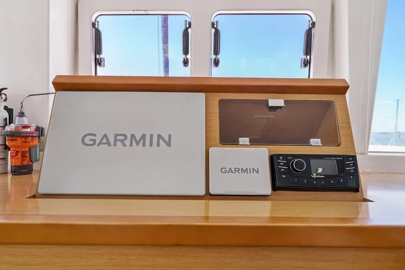 Worth The Wait Yacht Photos Pics Garmin navigation system on 2012 Lagoon 560 yacht dashboard, featuring modern controls.