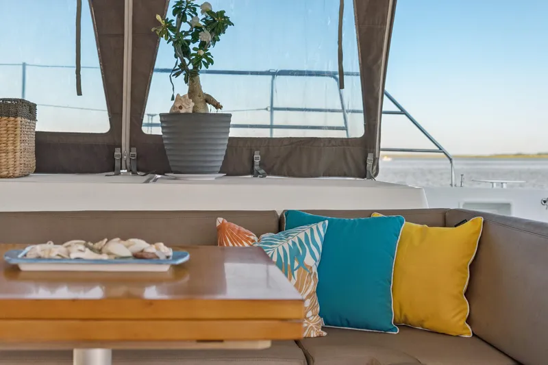 Worth The Wait Yacht Photos Pics Cozy Lagoon 560 yacht interior with colorful cushions and potted plant, 2012 model.