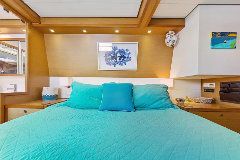Worth The Wait Yacht Photos Pics Luxurious bedroom interior of 2012 Lagoon 560 yacht with teal bedding and modern decor.