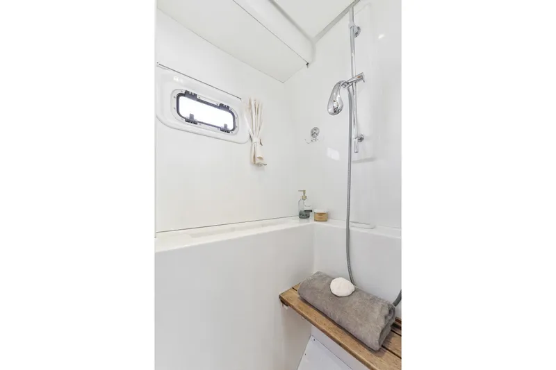 Worth The Wait Yacht Photos Pics Luxurious bathroom in 2012 Lagoon 560 yacht with shower and porthole window.