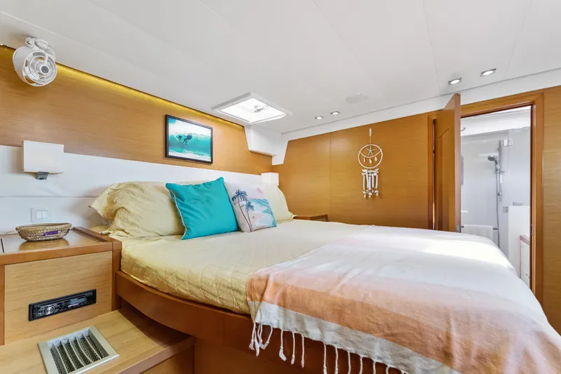Worth The Wait Yacht Photos Pics Luxurious bedroom interior of 2012 Lagoon 560 yacht with modern decor and cozy bedding.