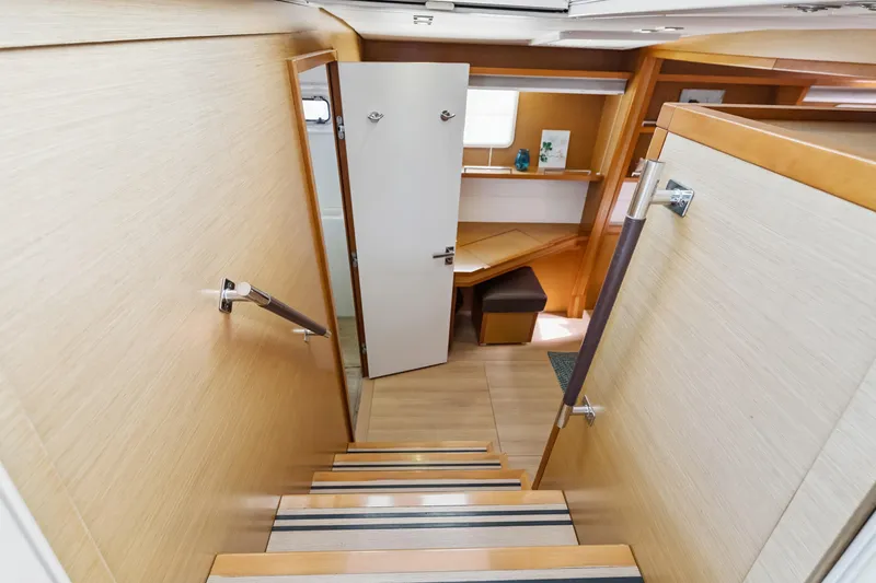 Worth The Wait Yacht Photos Pics Interior view of 2012 Lagoon 560 yacht, featuring wooden stairs and modern cabin design.