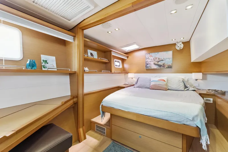 Worth The Wait Yacht Photos Pics Luxurious cabin interior of 2012 Lagoon 560 yacht with cozy bed and modern decor.