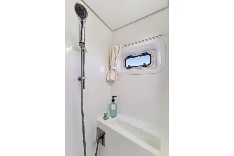 Worth The Wait Yacht Photos Pics Luxurious shower area in 2012 Lagoon 560 yacht with window and modern fixtures.