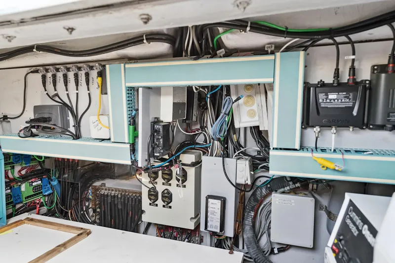 Worth The Wait Yacht Photos Pics Electrical system of a 2012 Lagoon 560 yacht, showcasing wiring and control panels.