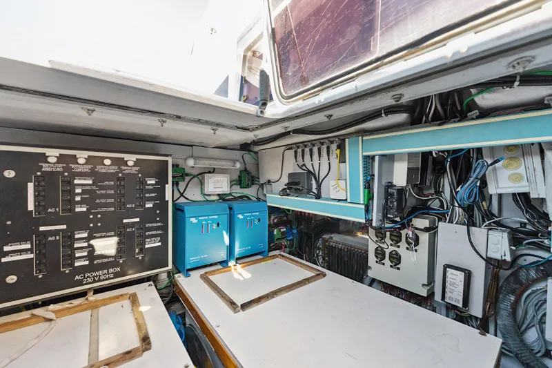 Worth The Wait Yacht Photos Pics Electrical control room of a 2012 Lagoon 560 yacht, featuring panels and wiring.