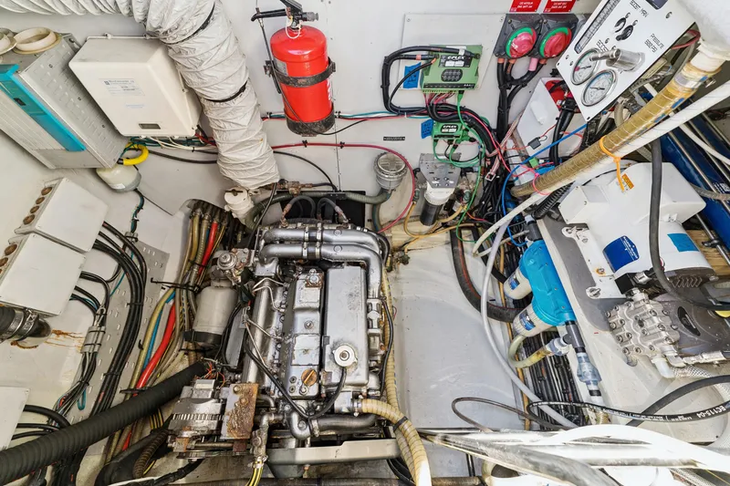 Worth The Wait Yacht Photos Pics Engine room of a 2012 Lagoon 560 yacht, featuring complex machinery and wiring.