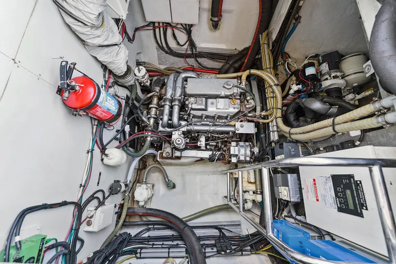 Worth The Wait Yacht Photos Pics Engine room of a 2012 Lagoon 560 yacht, featuring complex machinery and wiring.