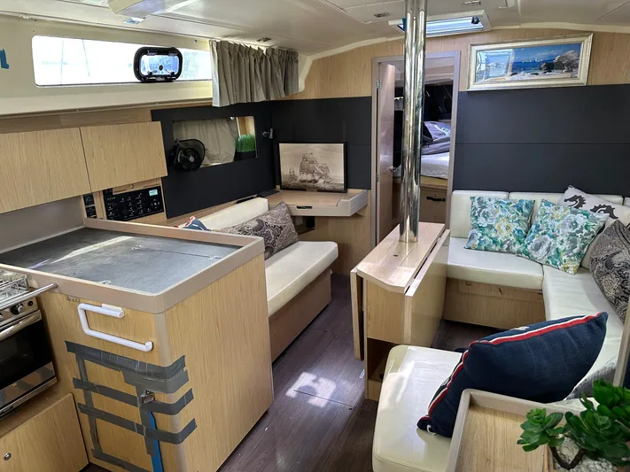  Yacht Photos Pics Interior of 2017 Beneteau Oceanis 41.1 yacht with modern kitchen and cozy seating area.