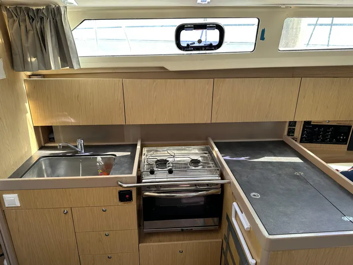  Yacht Photos Pics Interior of 2017 Beneteau Oceanis 41.1 yacht kitchen with stove, sink, and cabinets.