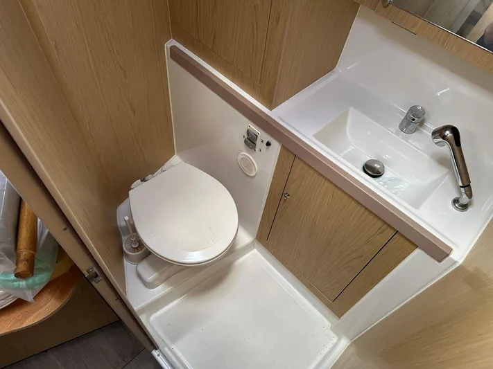  Yacht Photos Pics Bathroom interior of 2017 Beneteau Oceanis 41.1 yacht, featuring toilet and sink.
