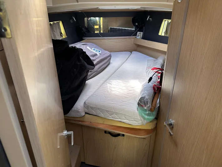  Yacht Photos Pics Cozy cabin interior of 2017 Beneteau Oceanis 41.1 sailboat with bed and wooden furnishings.
